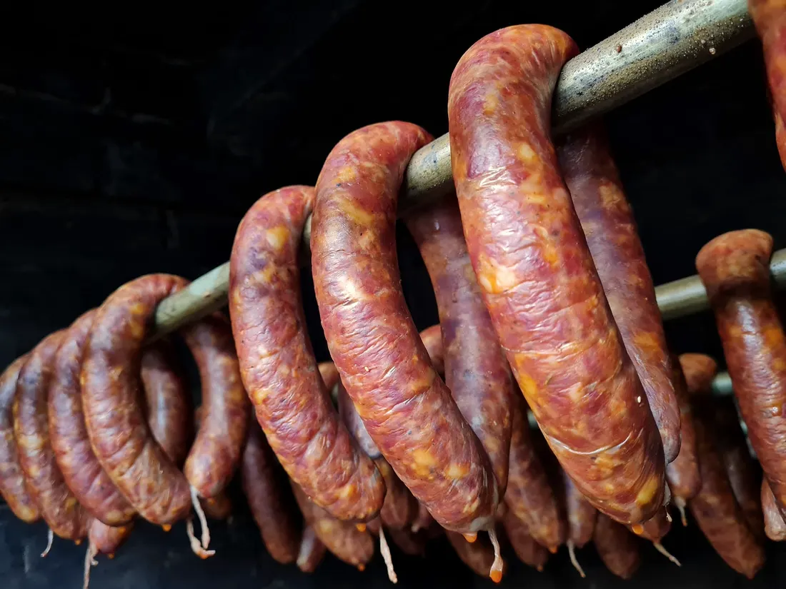 Sausages hanging on a smoking rod